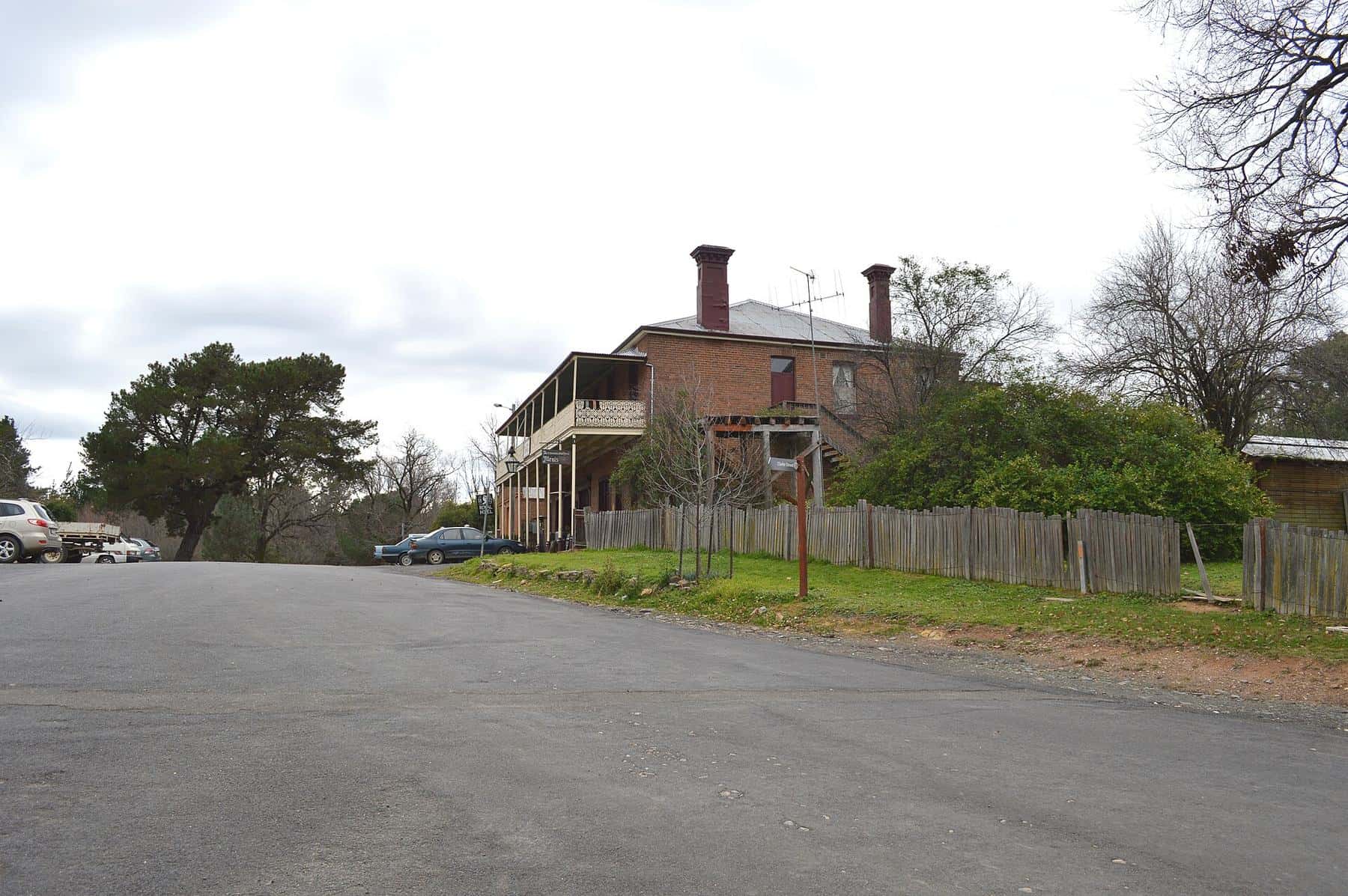 Wide tree-lined main street with historic buildings at Hill End
